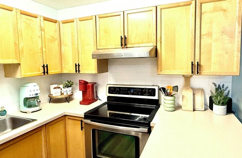 Panorama Condo | Boho theme, Ground floor patio with green space and creek view. 2 min to gondola