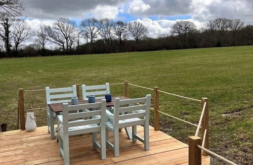 Pulborough Cabin | Boutique Shepherds Hut set in a wildflower meadow on a farm with Highland Cows