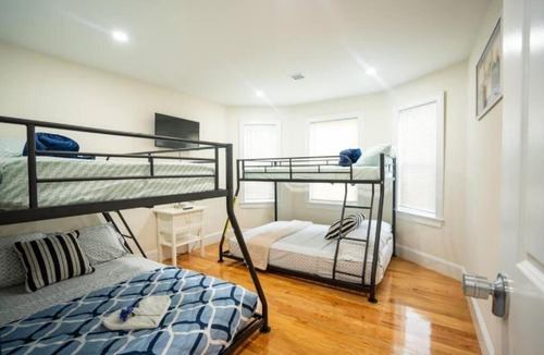 St. Marks Apartment | Breezy 3BR Boston Apt - Bathtub, Parking, TV, Walk to Train 803