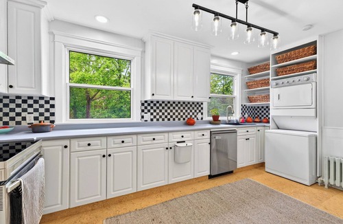 Queens Square House | Bright second-floor home with private deck, modern kitchen, and calm style.