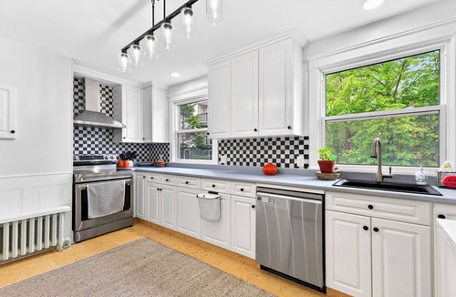 Queens Square House | Bright second-floor home with private deck, modern kitchen, and calm style.