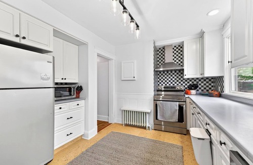 Queens Square House | Bright second-floor home with private deck, modern kitchen, and calm style.