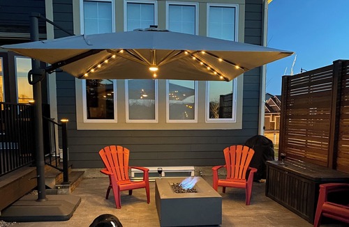Okotoks House | Bright, spacious family home with great a outdoor space overlooking green space.