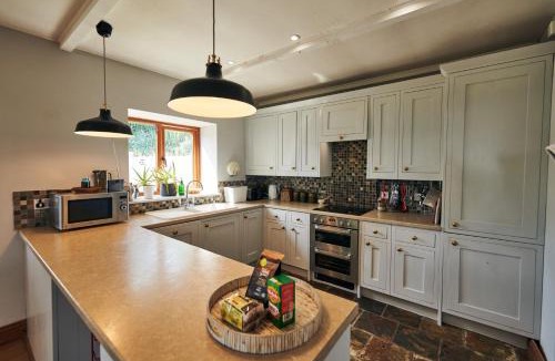 Llanybri House | Brofallen - Spacious bunglaow with distant sea views and enclosed garden