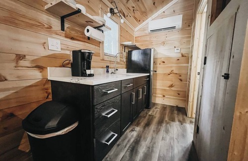Hartwell RV Rental | Cabin #4: Two queen-size beds with a kitchenette and a large gravel parking pad beside the cabin for easy boat or trailer storage.