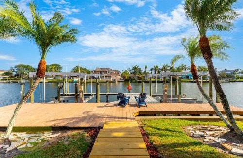 Cocoa Isles Villa | Casa De Olas - Waterfront Luxe Home - Heated Pool - Game Room - Boat Lift - Minutes to Beach