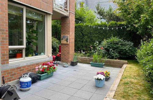 Central Lonsdale Apartment | Central and quiet 2 bedroom townhouse with private patio, parking, gym