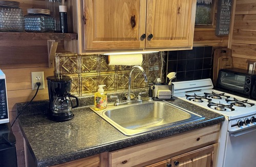 Kerrick Cabin | Charming cabin in delightful Duquette with AC near miles of ATV trails.