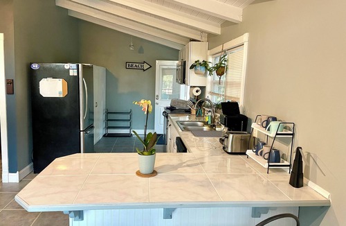 Butler Beach House | Charming Canal Front Cottage! Walk to the Beach!