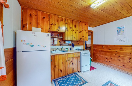 Indian River Cottage | Charming lakefront cottage with large yard, dock, & fire pit - close to downtown