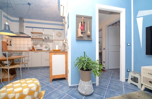 Arona Apartment | Charming one-bedroom apartment, finely furnished, located on the ground floor of Via Pertossi in the historic centre of Arona.Casa Azzurra is a 52 sqm one-bedroom apartment with air conditioning, featuring a living room/kitchen area with a double sofa be