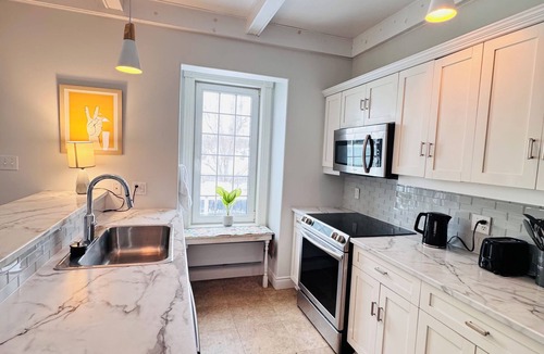 Antigonish House | Charming Sunroom Home with Cozy Living Spaces