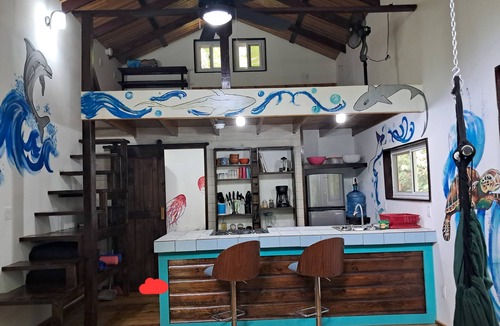 Carenero Island Cottage | Charming Tiny House, 1 minute walk to surf and beaches, peaceful.