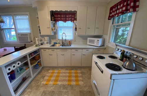 Markesan Cottage | Classic Green Lake cottage, lakefront, screened boathouse deck, dock, swimming