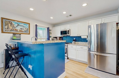 Eden Pines House | Coastal canalfront home with swim spa, dock, kayaks, e-bikes & dog friendly