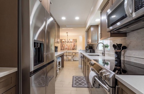 Tropic Palms House | Coastal retreat with heated saltwater pool & spa in prime Delray Beach.