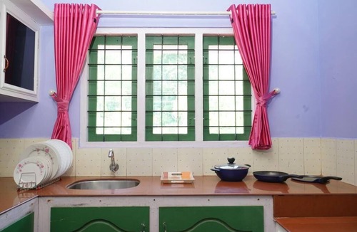 Devikolam House | Colorful Facade with greenery Nest Stay