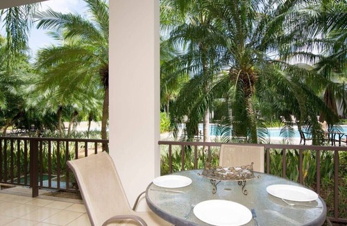 Coco Condo | Colorful Poolside Condo w/Garden-View Patio & Resort-Style Amenities