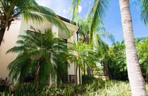 Coco Condo | Colorful Poolside Condo w/Garden-View Patio & Resort-Style Amenities
