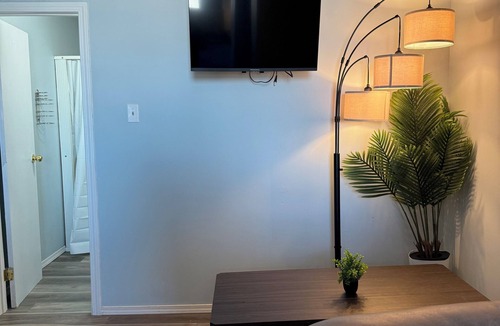 The Pas Apartment | Comfortable Queen Room with a recliner in a Hotel