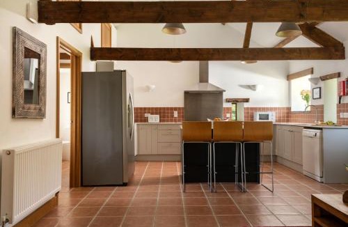 Widegates House | Corn Barn at East Trenean Farm -Luxury Cornish Barn Conversion sleeping 8 with hot tub, private garden, rural views and EV facilities