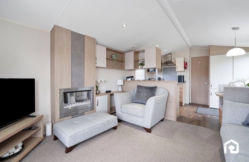 Longniddry Apartment | Cozy and modern caravan in beautiful Seton Sands Holiday Park — perfect for a seaside escape! Just minutes from the beach and park facilities, it features a comfy lounge, fully equipped kitchen, and outdoor seating area.