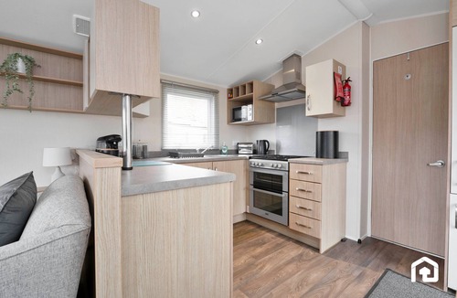 Longniddry Apartment | Cozy and modern caravan in beautiful Seton Sands Holiday Park — perfect for a seaside escape! Just minutes from the beach and park facilities, it features a comfy lounge, fully equipped kitchen, and outdoor seating area.