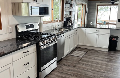 Shawano Cottage | Cozy Lakefront Cottage — Sunsets, Kayaks, Fishing, Paddleboards, Water Mat