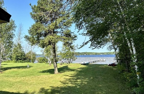 Germfask Cottage | Cozy log cabin on South Manistique Lake with 100 feet of sandy beach, sunsets