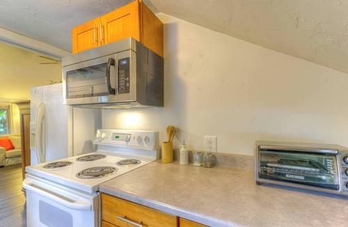 Greenwood Apartment | Creek-Front Crown Hill Craftsman with Hot Tub