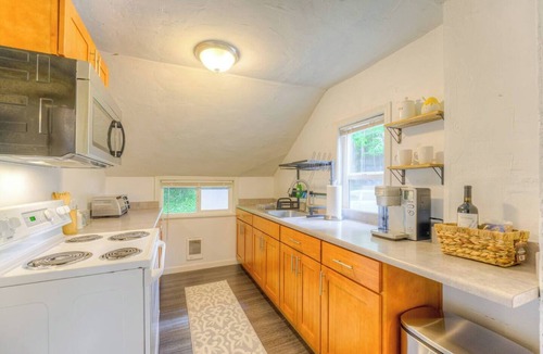 Greenwood Apartment | Creek-Front Crown Hill Craftsman with Hot Tub
