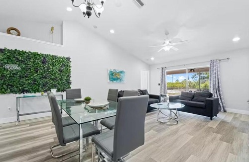 Palm Beach Shores Apartment | Dog friendly condo with beach access, hot tub & firepit