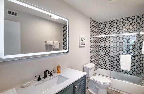 Palm Beach Shores Apartment | Dog friendly condo with beach access, hot tub & firepit