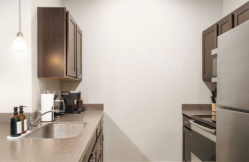 Lawrence Apartment | Downtown Lawrence Condo 1 Block to Mass St Walk to KU Hot Tub Sleeps 4