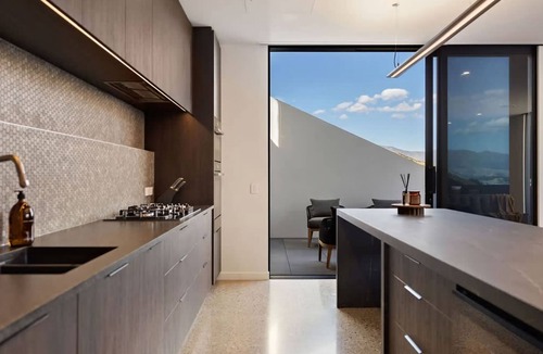 Frankton House | Elevated Elegance is a luxury retreat with dramatic views of the lake & mountains.