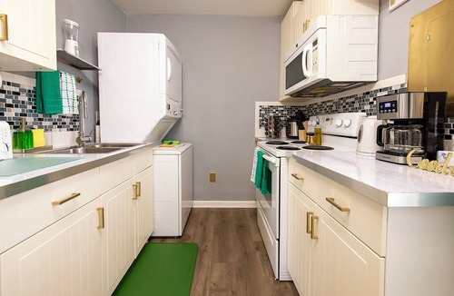 Tremont House | Emerald Oasis: Tremont 4BR Duplex by Christmas Story House | Patio, Laundry, Parking 7 Min Downtown