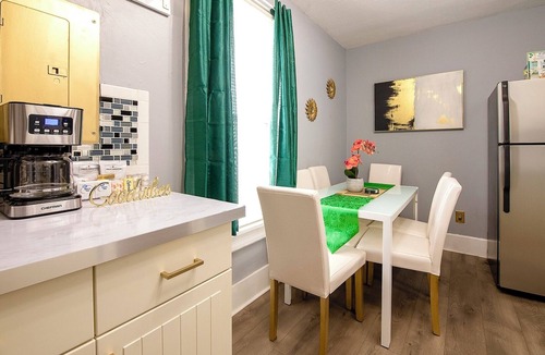 Tremont House | Emerald Oasis: Tremont 4BR Duplex by Christmas Story House | Patio, Laundry, Parking 7 Min Downtown