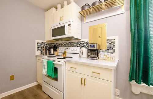 Tremont House | Emerald Oasis: Tremont 4BR Duplex by Christmas Story House | Patio, Laundry, Parking 7 Min Downtown