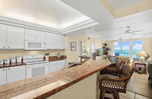 Ponce Inlet Condo | Enjoy this beachfront 2BR condo in Ponce Inlet with a ground-level patio offering direct access to pool and beach. Features a heated pool, fitness room, and clubhouse. Master has a king bed with private bath; guest room includes a king and two twins