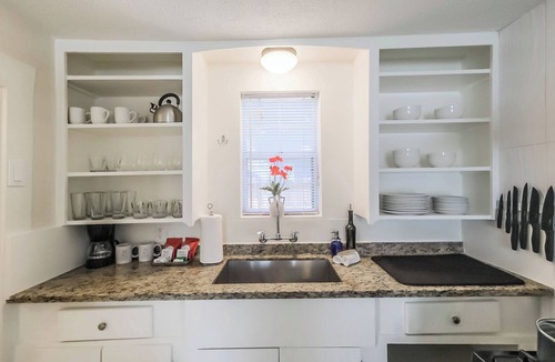 Shady Acres House | Enjoy two separate, fully furnished homes on one property — perfect for large groups. The front one-story home offers 3 bedrooms and 1 bath, while the back two-story home features 3 bedrooms, 2 baths, and an upstairs family room with 2 beds
