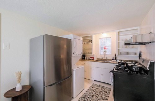 Shady Acres House | Enjoy two separate, fully furnished homes on one property — perfect for large groups. The front one-story home offers 3 bedrooms and 1 bath, while the back two-story home features 3 bedrooms, 2 baths, and an upstairs family room with 2 beds