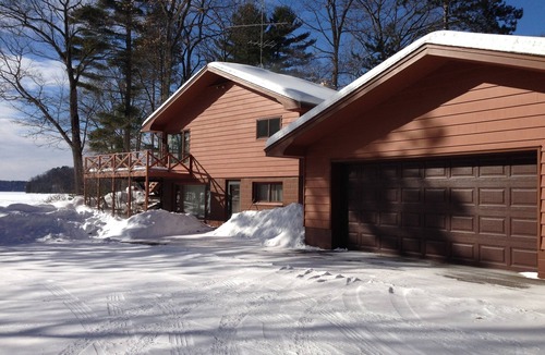 Eagle River House | Escape to the Northwoods at this picturesque Sand Lake home