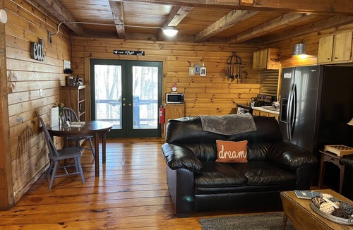 Carbon Hill Cabin | Evergreen Hideaway is a cabin nestled under tall pines.