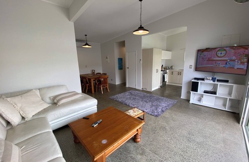Manly House | Experience a Kiwi beach holiday here, a couple of minutes walk to the sand .