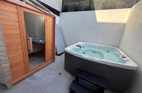 Corona del Mar Condo | Experience a luxurious 4-bedroom, 4.5-bath mid-century modern coastal escape in Corona Del Mar, CA. Steps from the Pacific Ocean, this fully remodeled home features a gourmet kitchen, private hot tub, sauna, and Cntrl4 system. Comfortably fits 10