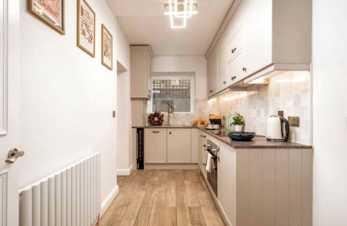 West Kensington Apartment | Experience Central London from this stylish, 1-bedroom apartment in Kensington & Chelsea, featuring a private patio, super king bed, modern kitchen, fast WiFi, and a cozy lounge — ideal for couples, digital nomads, or short city stays.