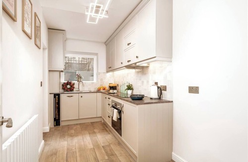 West Kensington Apartment | Experience Central London from this stylish, 1-bedroom apartment in Kensington & Chelsea, featuring a private patio, super king bed, modern kitchen, fast WiFi, and a cozy lounge — ideal for couples, digital nomads, or short city stays.