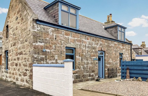 Sandhaven Cottage | Experience cosy comfort in this Cairnbulg holiday home, featuring a log fire.