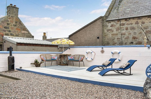 Sandhaven Cottage | Experience cosy comfort in this Cairnbulg holiday home, featuring a log fire.