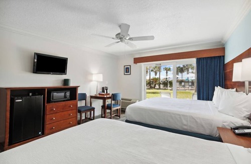 Neptune Beach Hotel | Explore Local Gems from a Relaxing Beachfront Room with Outdoor Swimming Pool